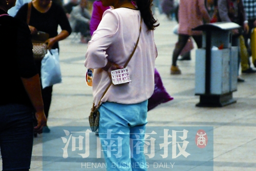 火車站廣場，一女子拿著寫有不同房型價(jià)位的卡片在拉客，不少市民抱怨，受過此類“騷擾”