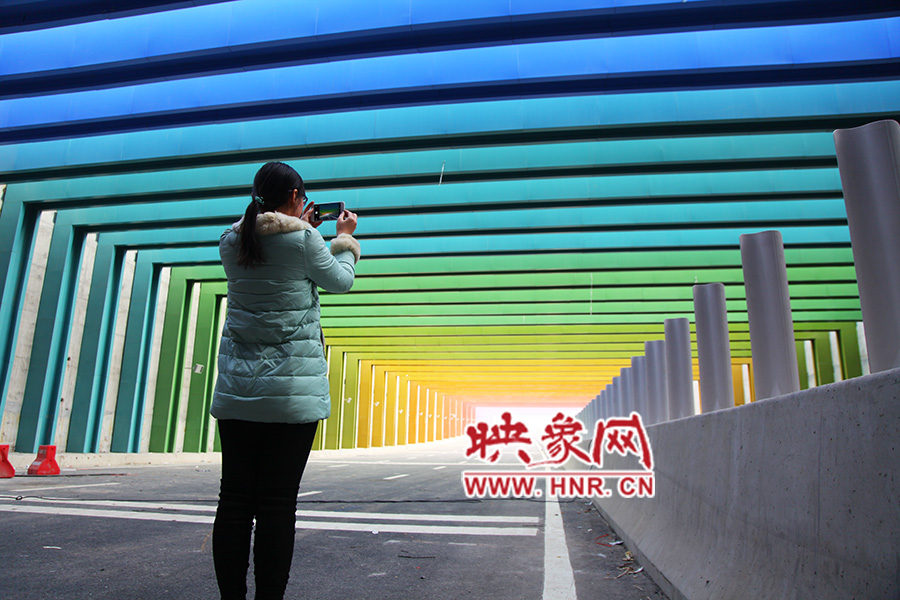 一女孩拿出手機(jī)拍照。