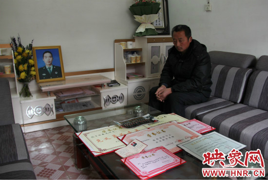 救火英雄鄭春光的父親和兒子獲得榮譽(yù)證書。