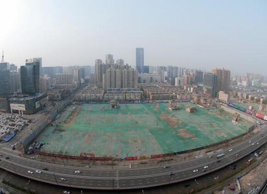 2016年4月，經(jīng)過持續(xù)攻堅，親賢社區(qū)西北片區(qū)的拆遷工作基本告一段落，但在鋪設(shè)了防塵綠網(wǎng)的空地中，至今仍有3戶居民選擇了“堅守”。(拍攝：2016年4月4日)