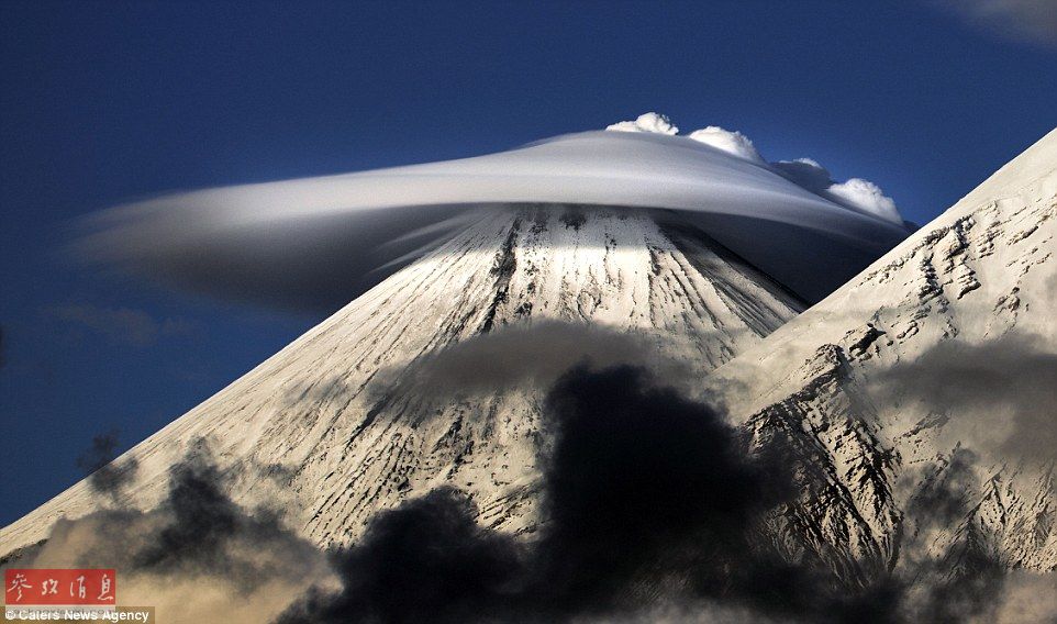 火山上籠罩著類似于外星飛碟形狀的云彩，場(chǎng)景猶如科幻大片。