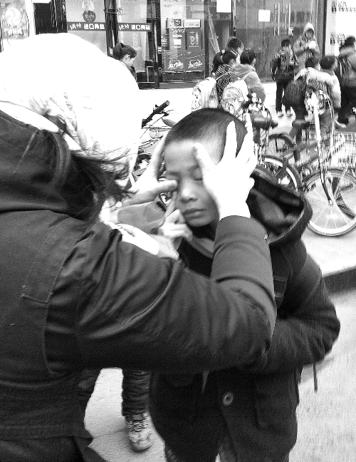 春天風(fēng)沙大，一孩子被風(fēng)沙瞇了眼